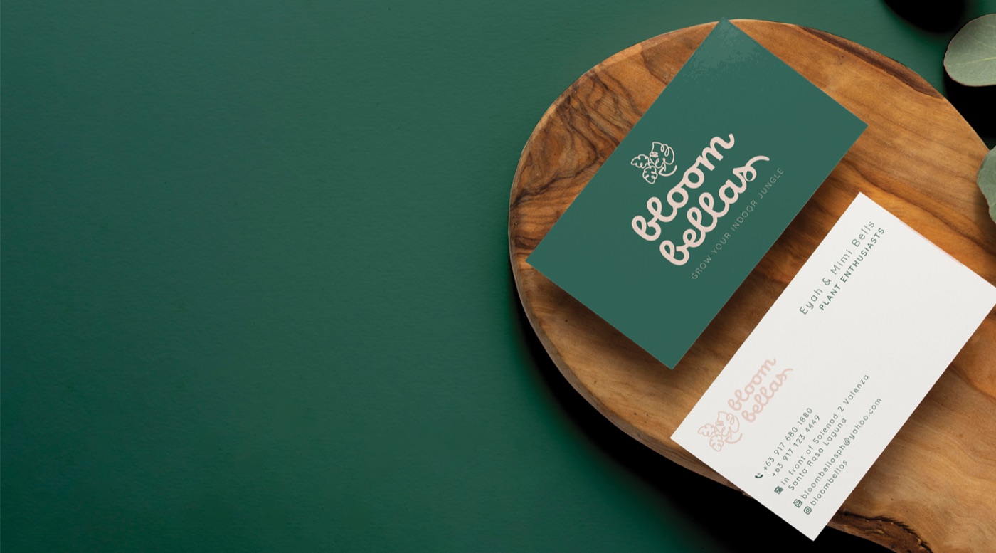 Bloombellas business card on a deep green background.