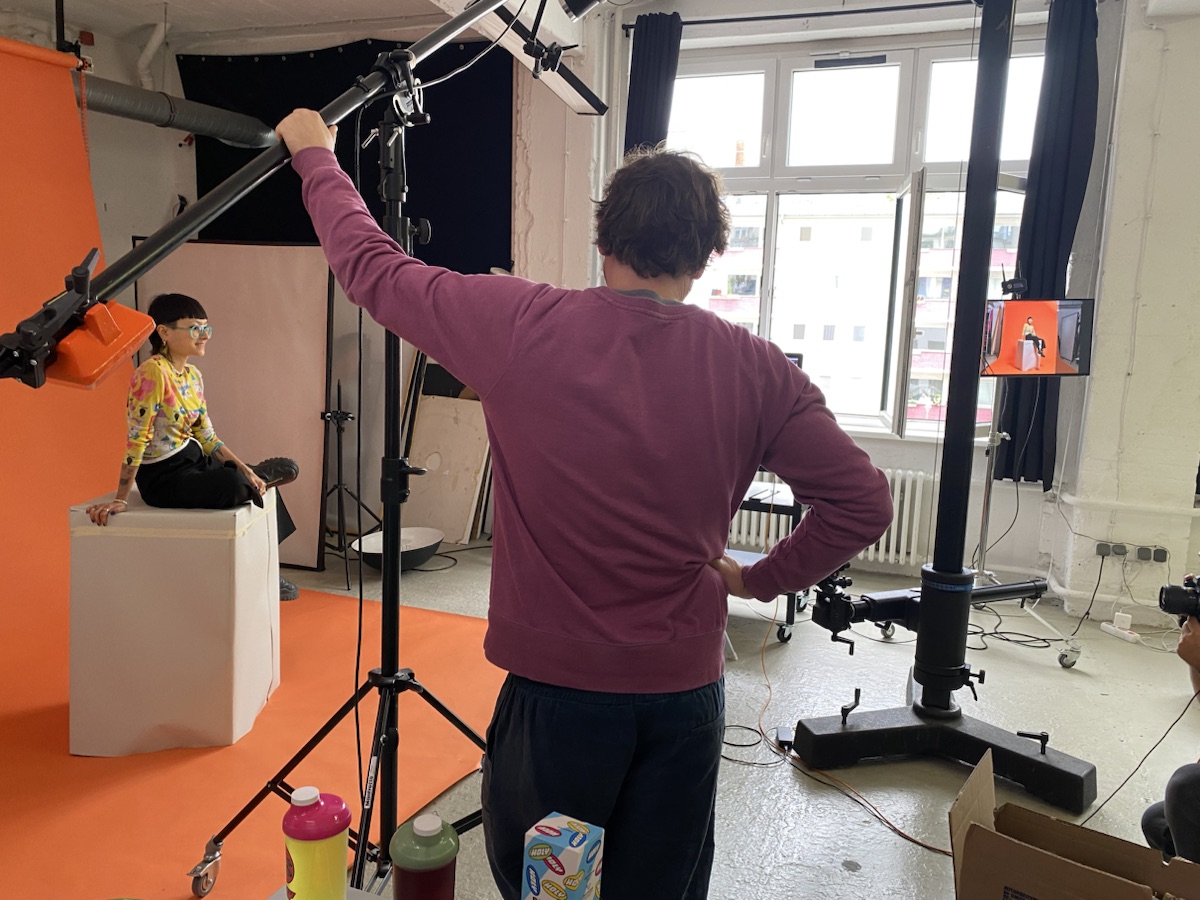 A HOLY campaign photoshoot in progress on a colourful studio set.